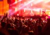 Crowd at concert with vibrant stage lights
