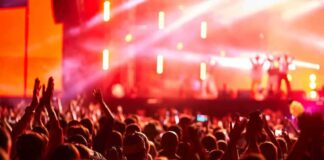 Crowd at concert with vibrant stage lights