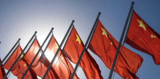 Red flags with yellow stars on flagpoles