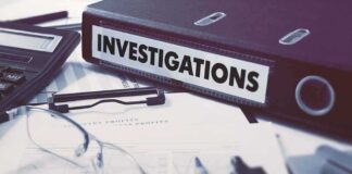 Documents and binder labeled investigation on desk.