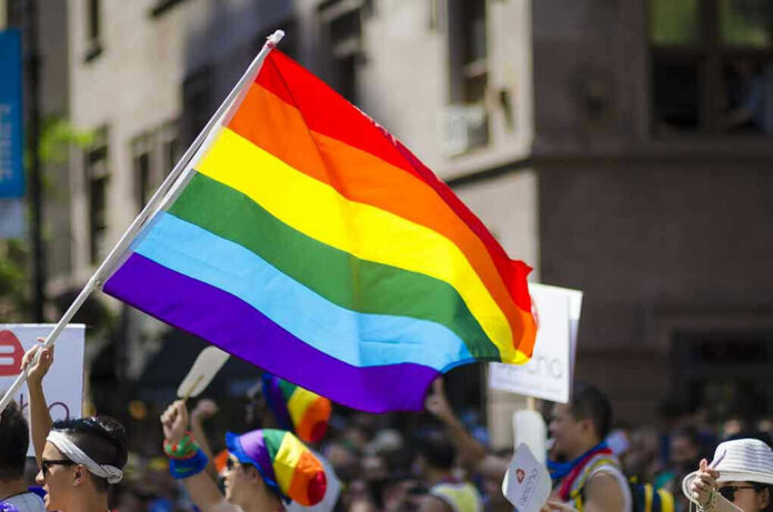 522918778 People holding and waving a rainbow flag