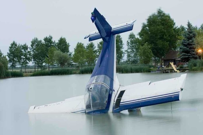 shutterstock_49499650.jpg A submerged airplane partially in a lake with trees in the background