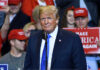 Person at a rally with Make America Great Again signs