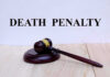 "Gavel with 'Death Penalty' text background."