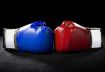 Blue and red boxing gloves facing each other