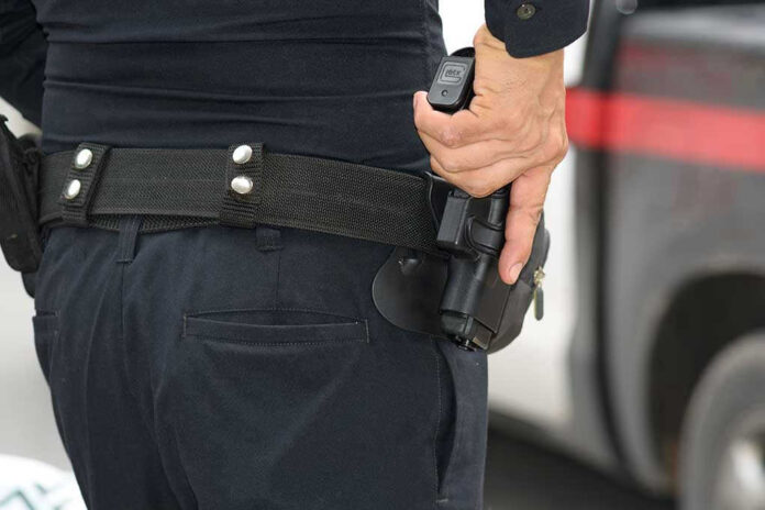 Person holding a gun in a holster