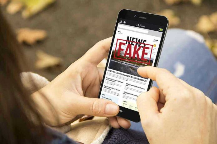 Person holding smartphone displaying fake news notification