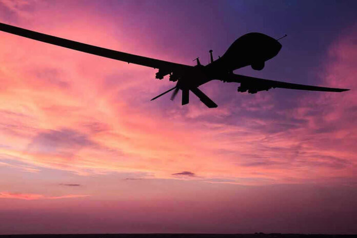 Silhouette of a drone against a colorful sunset