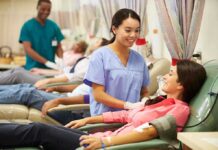 A nurse smiling at a female donor during a blood donation session