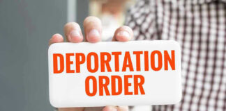 Hand holding sign with Deportation Order text.
