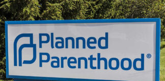 Planned Parenthood sign on a grassy lawn.
