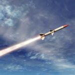 A missile ascending into the sky with a trail of smoke