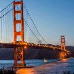 Brutal Daylight Murder Shocks San Francisco Golden Gate Bridge at dusk with lights on.