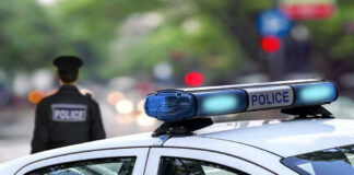 Police car and officer on a city street.