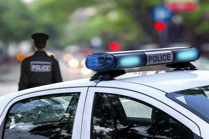 Police car and officer on a city street.