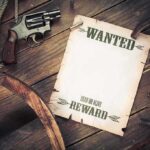 Cartels Offer KILL BOUNTIES on Federal Agents A vintage wanted poster alongside a revolver and rope on a wooden table