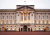 Royal SHOCK — Titles VANISH! Front view of Buckingham Palace with illuminated facade and British flag