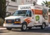 A U-Haul moving truck parked on a residential street