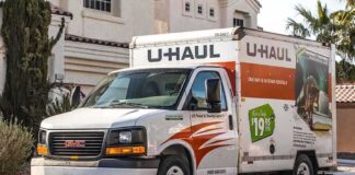 A U-Haul moving truck parked on a residential street