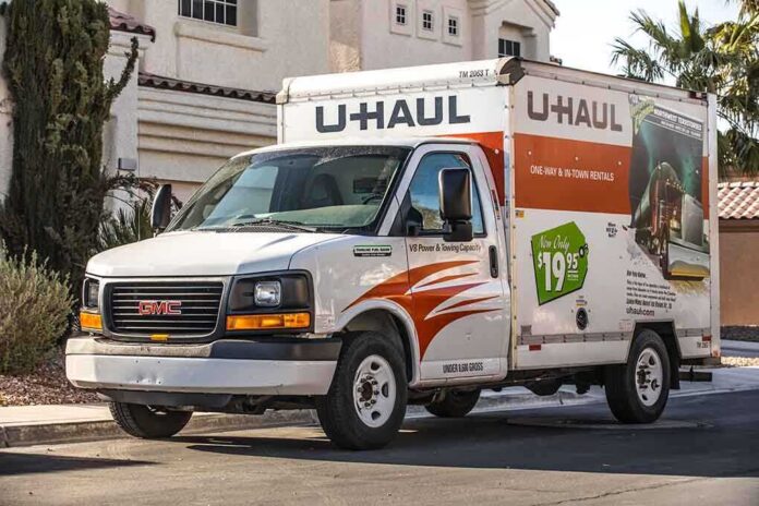 A U-Haul moving truck parked on a residential street