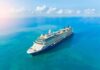 A large cruise ship sailing on a calm blue ocean