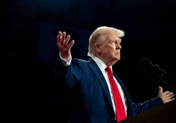 shutterstock_2512443159.jpg A man in a suit gesturing during a speech