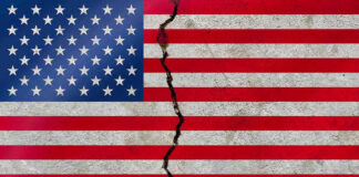 American flag with a large crack through it.