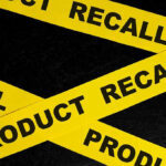 Botulism Scare Shakes Formula Industry — CASES MOUNTING Yellow tape with product recall text on black background.