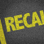 Toyota’s Reliability SHATTERS—Engine Disaster Stuns Owners Yellow RECALL text on asphalt background.