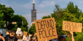 Protesters holding signs advocating for police reform
