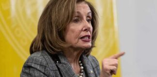 A female politician passionately speaking with an expressive gesture