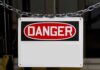 A warning sign displaying the word DANGER in bold red letters