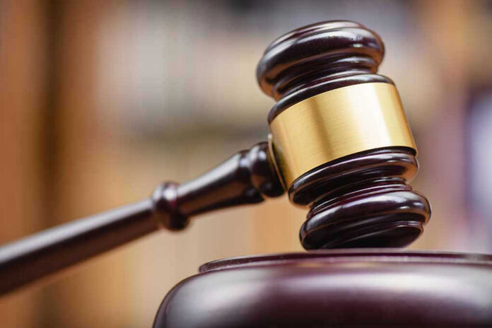 Judges gavel striking a sound block.