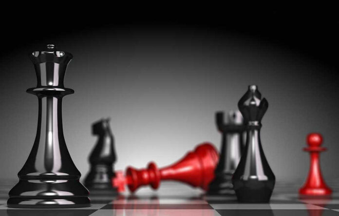 135258992 Black and red chess pieces on a board.