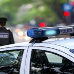 Police car and officer on a city street.