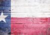 Texas flag displayed on a wooden background