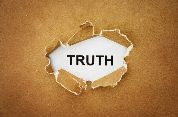 A piece of torn paper revealing the word TRUTH underneath