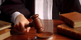 Judges gavel on desk with books.