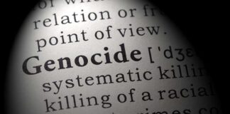Close-up of the word Genocide in a dictionary