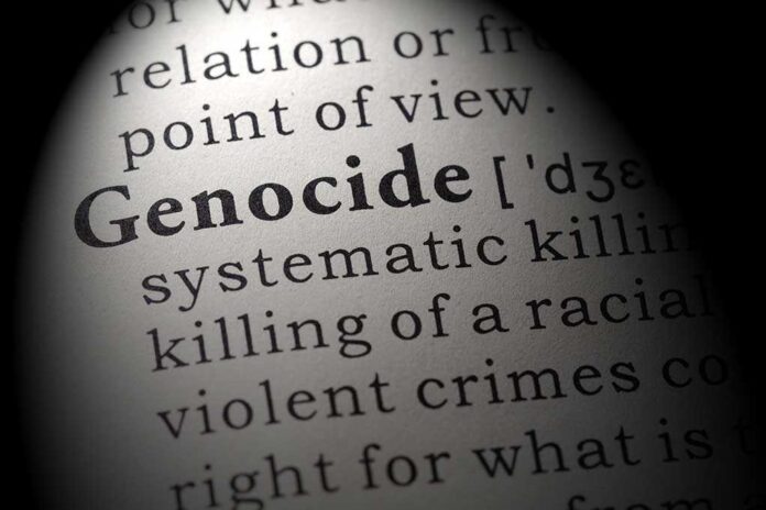 Close-up of the word Genocide in a dictionary