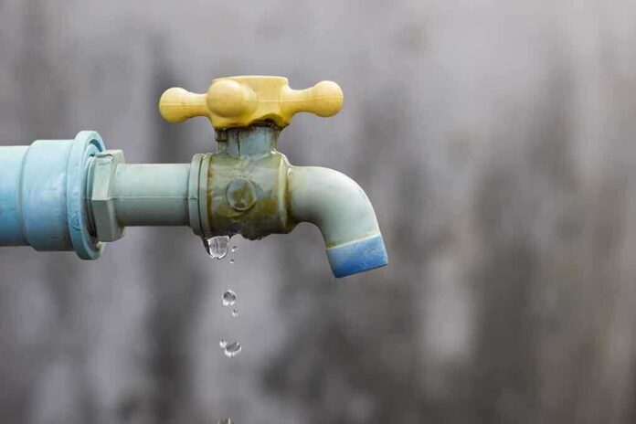 Close-up of a dripping outdoor water faucet