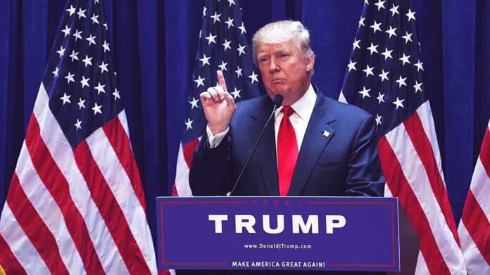 Donald Trump delivering a speech at a podium with American flags in the background