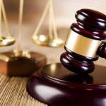 Democrats CAUGHT Violating State Law—Scheme DESTROYED A wooden gavel and scales of justice on a table
