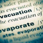 Iran Threatens Retaliation — EVACUATION BEGINS Close-up of a dictionary page showing the definition of evacuation