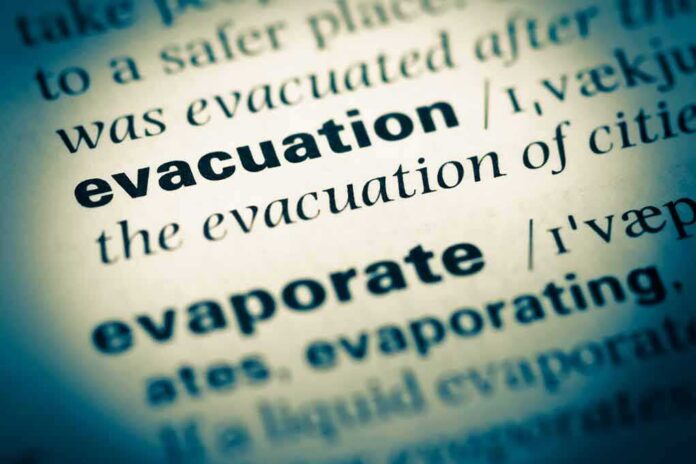 Close-up of a dictionary page showing the definition of evacuation