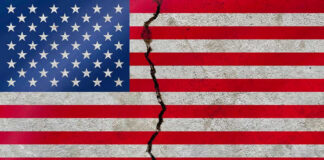 American flag with a large crack through it.