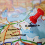 Red pushpin marking Baltimore on a map.