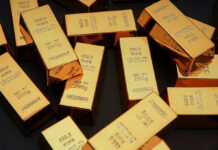 $5.2 Billion Gold Heist EXPOSED After Arrest Gold bars stacked on dark background