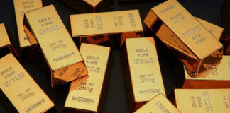 Gold bars stacked on dark background