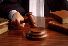 Judge BUSTS Arsonist’s Shocking AI Deception Judges gavel on desk with books.